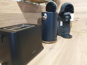 a toaster sitting on the floor next to a camera at Le duplex du 71 B in Niort