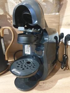 a coffee maker sitting on top of a table at Le duplex du 71 B in Niort +12 photos