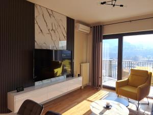 a living room with a large flat screen tv at Anika Luxury apartment at Diamond center in Skopje