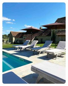 una fila de tumbonas y sombrillas junto a una piscina en Domaine de Ronsard, en Dame-Marie