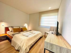 a bedroom with a bed and a television in it at Marinhas Nature in Marinhas