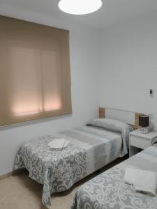 Postel nebo postele na pokoji v ubytování Las Palmeras