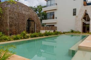 a swimming pool in front of a house at New luxury studio with plunge pool in Tulum +50 photos