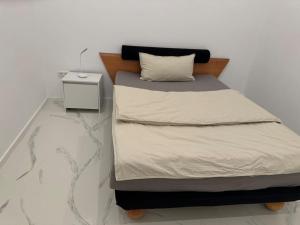 a bedroom with a bed with a night stand at Gemütliche Wohnung in Heilbronn in Heilbronn