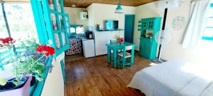 a room with a kitchen and a room with a table at La casita Espiritual in San Rafael