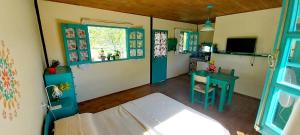 a room with a bed and a table and window at La casita Espiritual in San Rafael