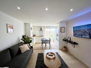 a living room with a couch and a table at Appartement les Falaises in Cap d'Agde