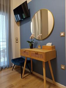 a bathroom with a dressing table and a mirror at Filoxenia Luxury Apartment in Nafplio