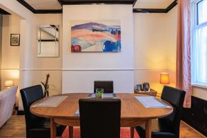 a dining room with a wooden table and chairs at Londonderry House in Stockton-on-Tees
