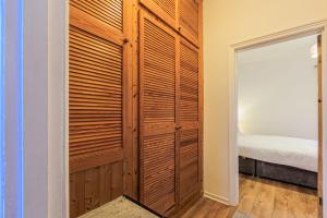 a closet with wooden doors in a bedroom at Londonderry House in Stockton-on-Tees