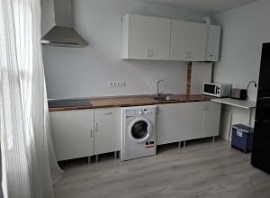 a kitchen with a washing machine and a sink at La Casona Santander Centro in Santander +15 photos