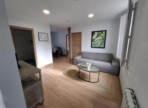 a living room with a couch and a table at La Casona Santander Centro in Santander