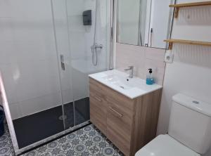 a bathroom with a shower and a sink and a toilet at La Casona Santander Centro in Santander