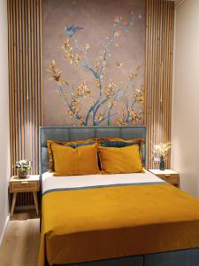 a bedroom with a large bed with yellow pillows at Filoxenia Luxury Apartment in Nafplio