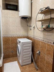 a white washer and dryer in a bathroom at Apartment Jovan2,on the beach with free Wi-Fi in Kotor