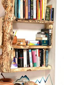 a book shelf full of books on a wall at Hippie Chic - Room L'oued in Essaouira
