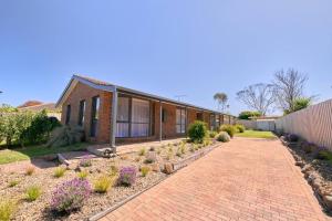 a brick house with a brick driveway at White Beach Nest walk to the beach in Torquay