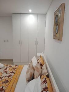 a white room with a bed and white cabinets at Riviera residence Studio Apartment in Otele