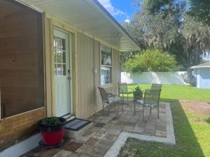 a porch of a house with chairs and a table at Peaceful Florida Studio in Lakeland