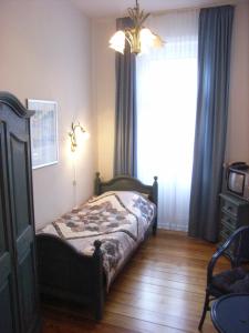 a bedroom with a bed and a large window at Hotel Villa im Steinbusch in Malente