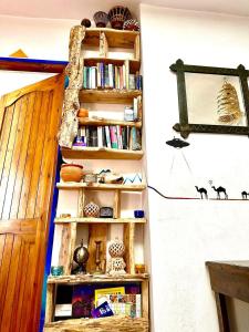 a book shelf on a wall with books at Hippie Chic House in Sidi Kaouki