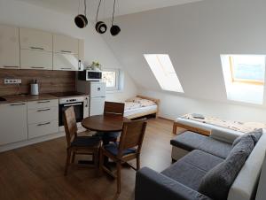 a living room with a table and a couch and a kitchen at Na břehu Těrlicka in Horní Těrlicko