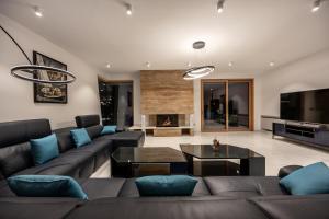 a living room with a couch and a table at Luxury Villa Con Brio in Pomer