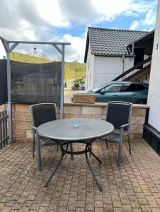 a table and two chairs on a patio at Maisonette Edna in Mechernich