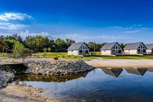 a row of houses with a reflection in the water at Willis Country Cabins- Couples Suite -#4 in Point