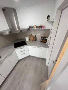 an overhead view of a kitchen with white cabinets at Casa la Única II in Benicarló +32 photos