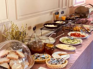 a buffet with many different types of food on a counter at Hotel Republika Berat in Berat