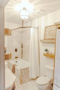a bathroom with a shower and a toilet and a tub at Willis Country Cabins-Sweet Escape -#3 in Point