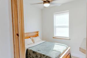 a bedroom with a bed with a ceiling fan and a window at Willis Country Cabins-Sweet Escape -#3 in Point +10 photos