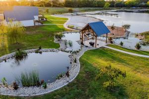an aerial view of a pond with a gazebo at Willis Country Cabins-Sweet Escape -#3 in Point
