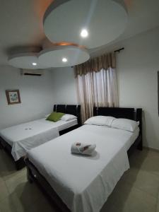 Postel nebo postele na pokoji v ubytování Hotel La Leyenda Vallenata