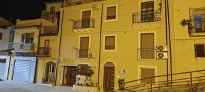 a yellow building with balconies on the side of it at All inBasilicata Bed & Breakfast in Baragiano