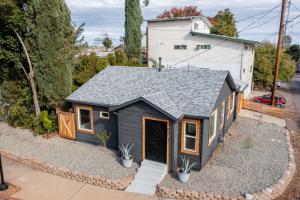 a tiny house with a gray roof at Charming downtown home by bike trail, river and coffee! in Redding