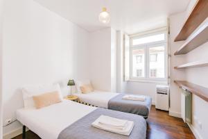 Postel nebo postele na pokoji v ubytování Chiado 2 Bedroom Elegant Apartment