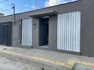 a building with a door on the side of it at Studio Brownie em Capim Macio in Natal +8 photos