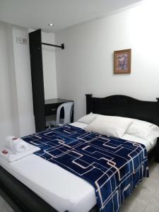 Postel nebo postele na pokoji v ubytování Hotel La Leyenda Vallenata