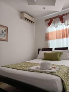 Postel nebo postele na pokoji v ubytování Hotel La Leyenda Vallenata