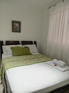 Postel nebo postele na pokoji v ubytování Hotel La Leyenda Vallenata