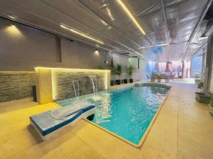 a large swimming pool in a large room at Lux private home Sheikh zayed in Sheikh Zayed