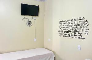 a room with a bed and a tv on the wall at Pousada Maré do Cerrado in Mateiros +46 photos