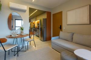 a living room with a couch and a table at Brasília a 400m do metrô in Brasilia