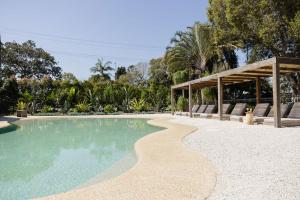 a swimming pool in a resort with a pavilion at The Brunswick, Brunswick Heads in Brunswick Heads
