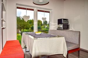 a dining room with a table and chairs and a window at Strandhaus in Heringsdorf