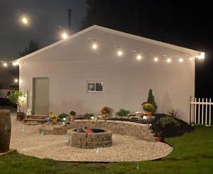 a house with a fire pit in the yard at night at Spacious Relaxing Baltimore Home with Hot Tub in Baltimore
