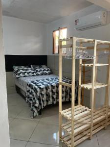 a bedroom with a bunk bed and a ladder at KitNet em Caraíva-Nova Caraíva in Caraíva