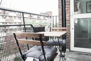 Un balcón con una mesa y sillas en un balcón. en Spacious 3 Bedroom Flat, en Londres